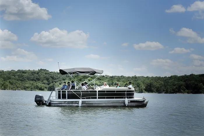 A pontoon boat crossing open water at Smithville Lake
