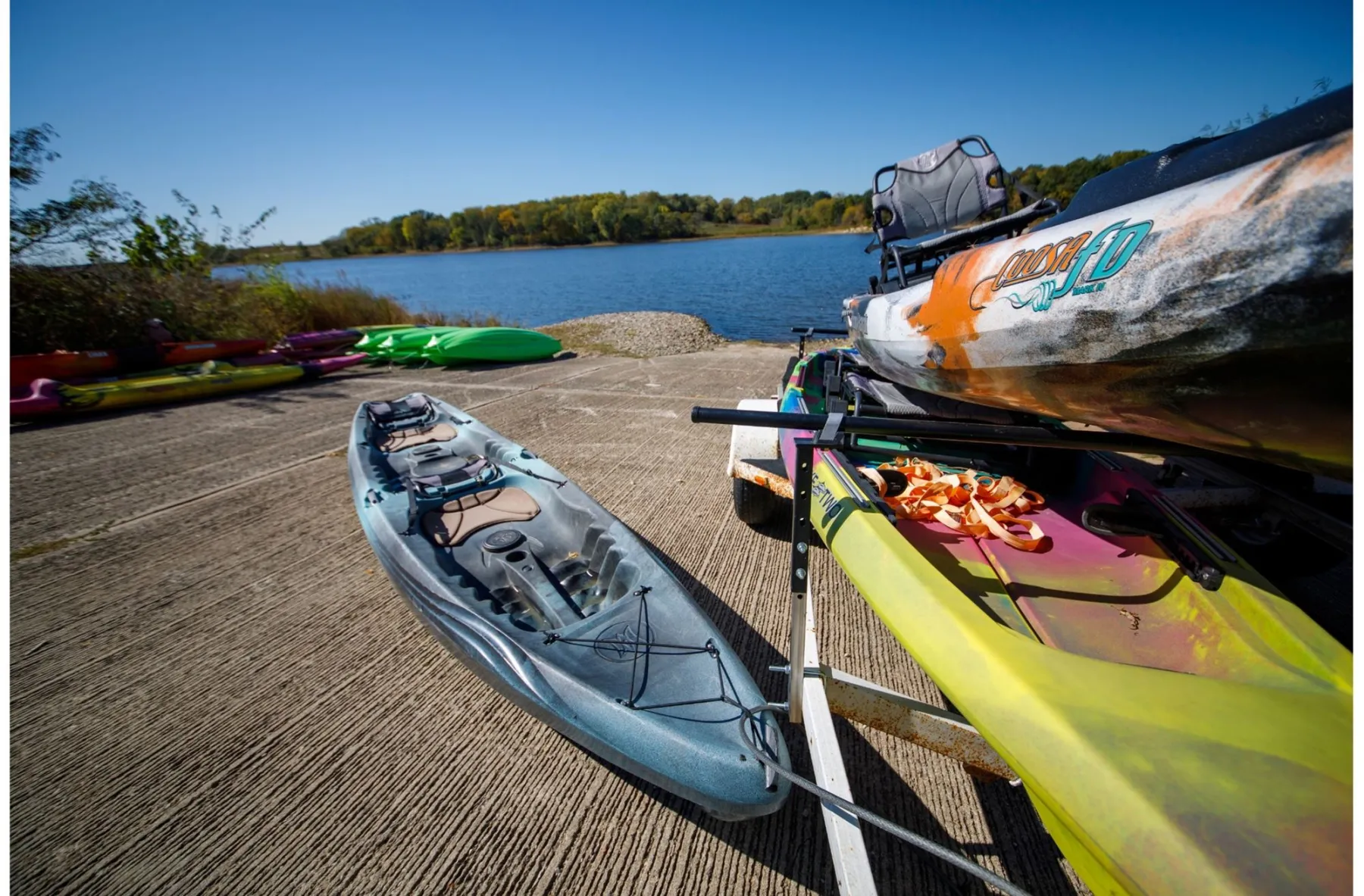 Kayaks lined up at a boat ramp on Smithville Lake under a clear blue sky